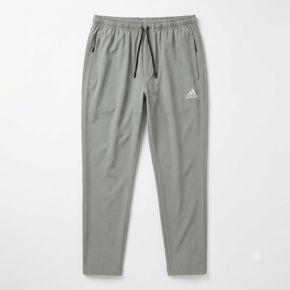 A pair of light gray Adidas jogger pants with a white logo on the left thigh, displayed flat against a clean white background.