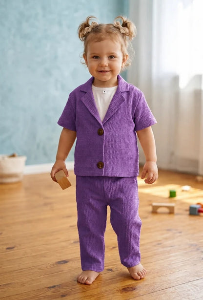 girl textured purple short-sleeve button-front jacket and matching pants.