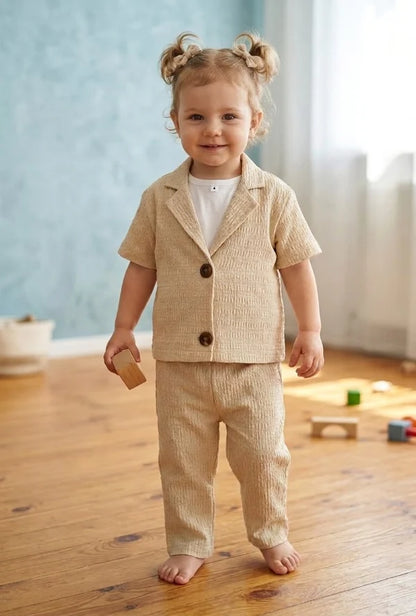 beige textured short-sleeve button-front jacket and matching pants over a white shirt. sale