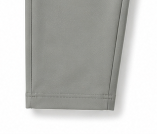 Close-up of a light gray Men's Track Trouser with ziper pocket, showing a clean stitched hem.